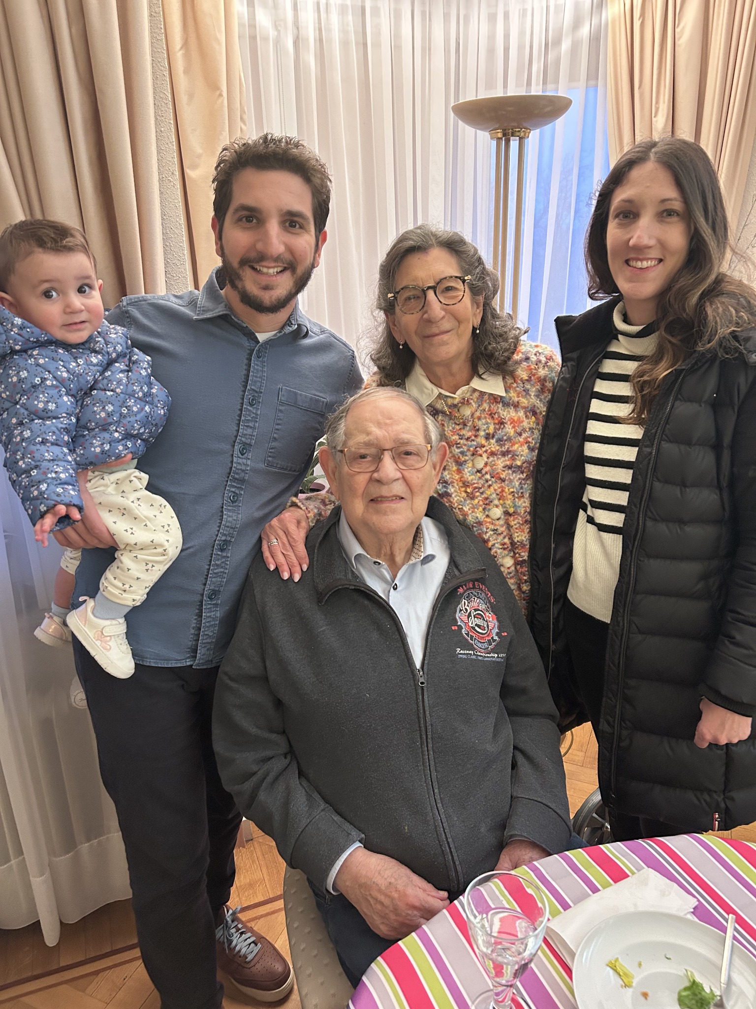 Mousani surrounded by family at home