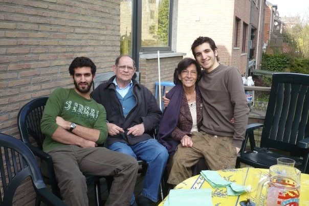 Mousani seated with family outdoors