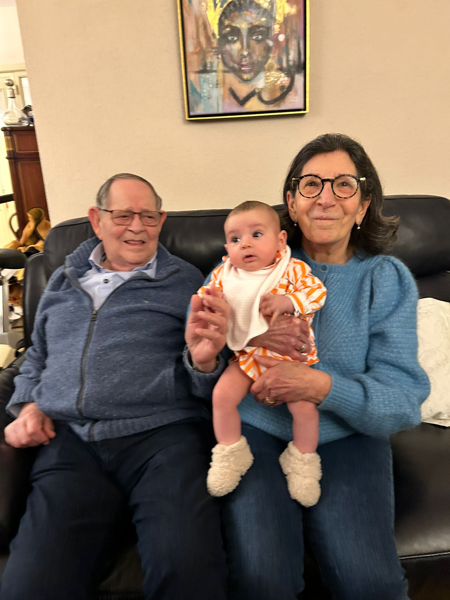 Mousani and his wife seated with a baby
