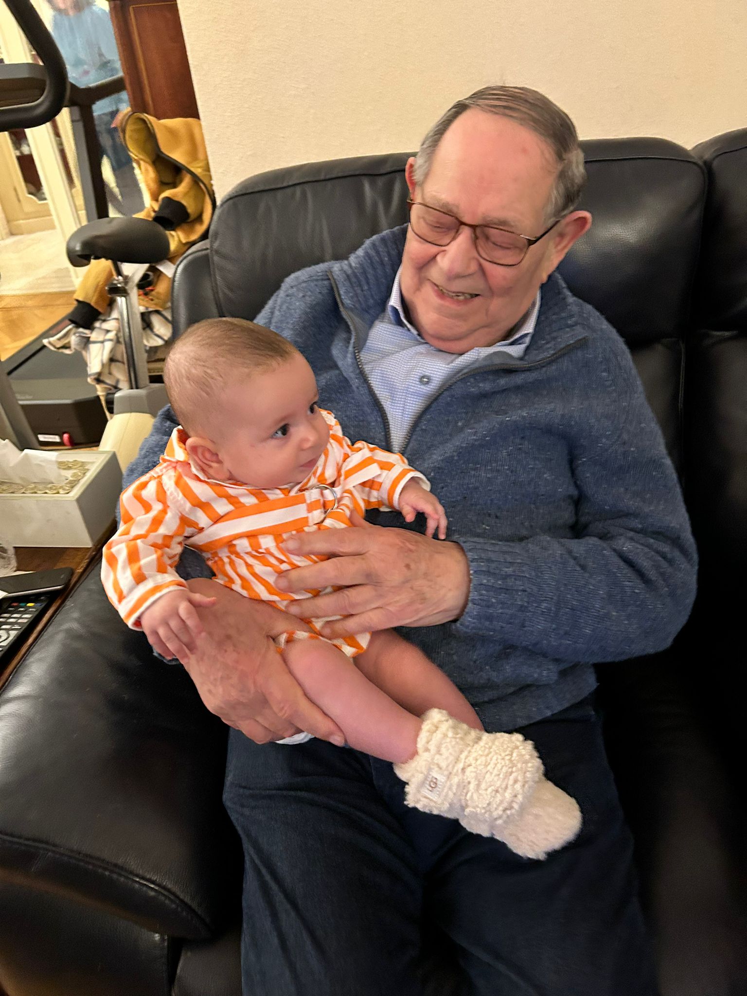 Mousani holding a baby at home