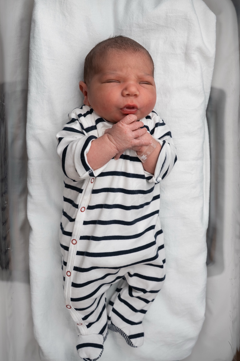 Eden Mousani Cohen in his striped newborn outfit