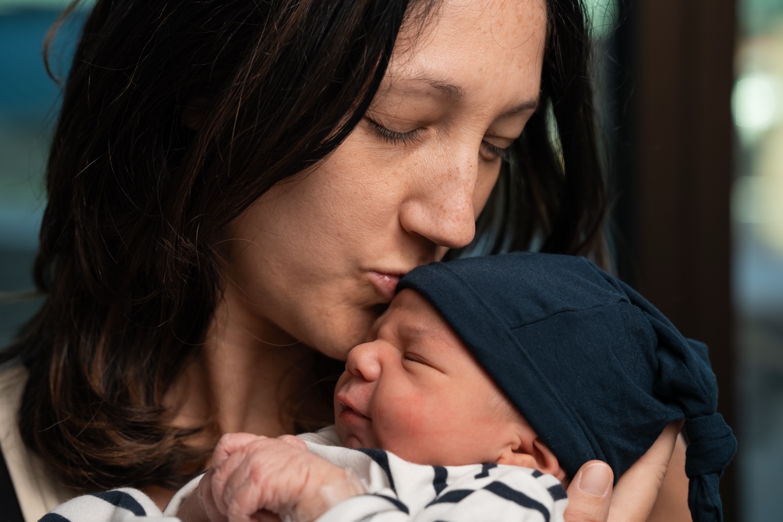 Emily kissing her newborn son
