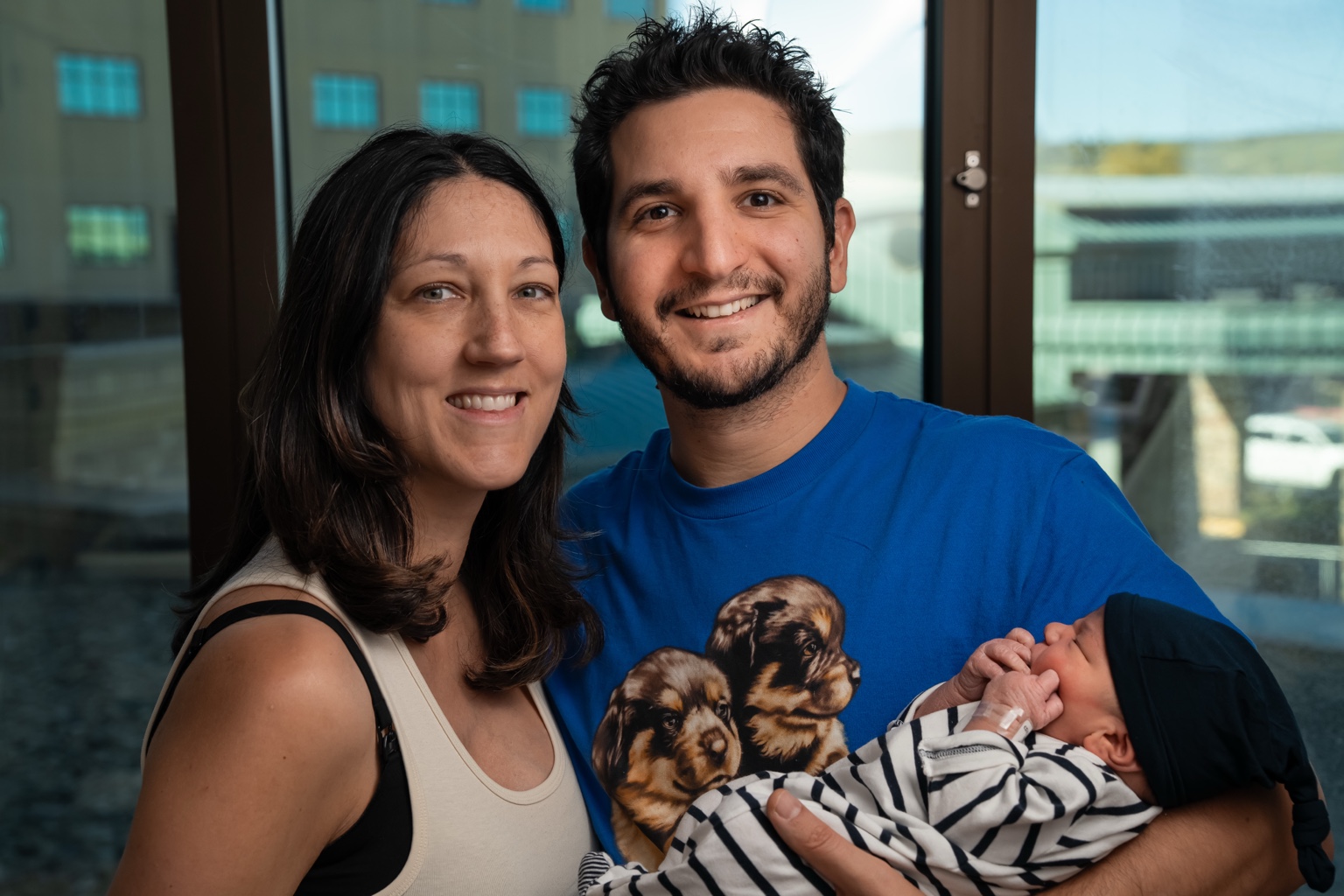 Emily and Steven holding Eden Mousani Cohen