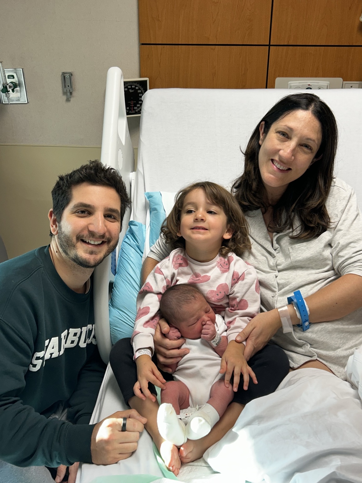 Emily, Steven, Sarah, and newborn Eden together in the hospital