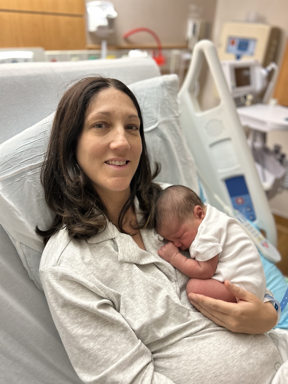 Emily holding newborn Eden in the hospital