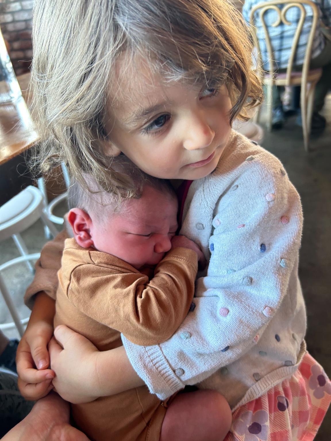 Sarah holding her baby brother Eden