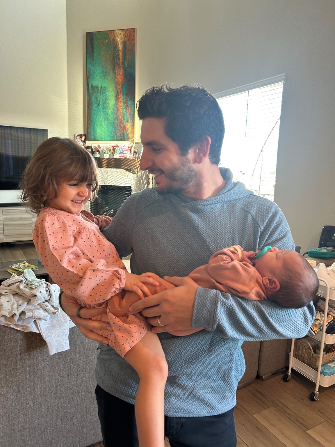 Steven holding Eden and Sarah at home